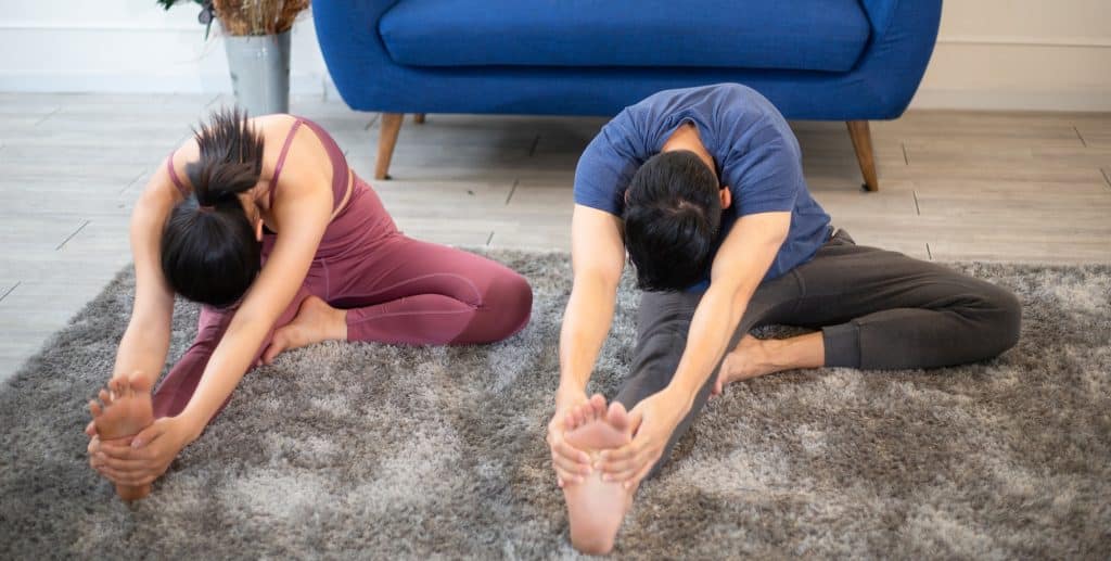 Couple stretching body before exercise